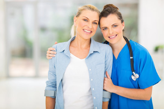 Young Nurse Standing With Disabled Patient