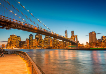 Amazing Manhattan skyline and Brooklyn Bridge after sunset with