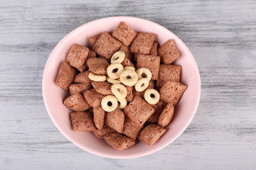 Dry breakfast in pink plate on wooden background