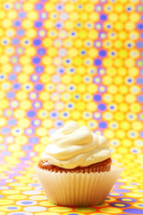 Delicious birthday cupcake on bright background