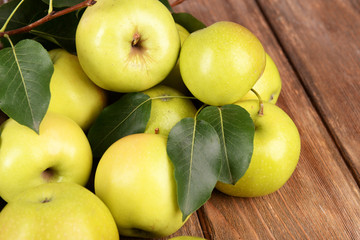 Ripe green apples on wooden background