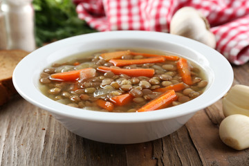 Delicious lentil soup on table close-up