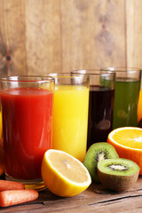 Fototapeta na wymiar Fruit and vegetable juice in glasses and fresh fruits and