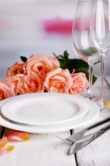 Table setting with pink rose on plate