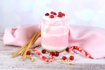 Raspberry milk dessert in glass jar,