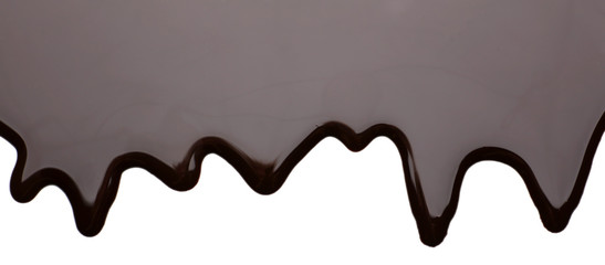 Melted chocolate dripping on white background