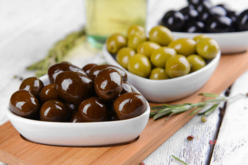 Different marinated olives on table close-up