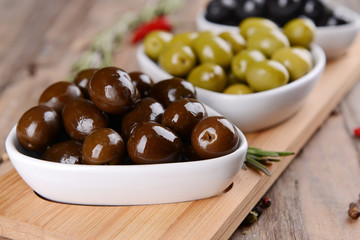Different marinated olives on table close-up