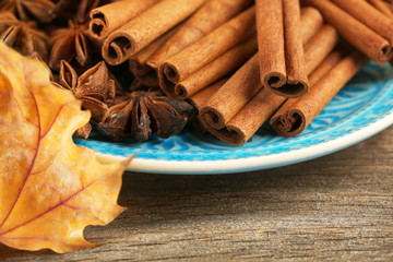 Cinnamon sticks and stars anise with yellow leaves