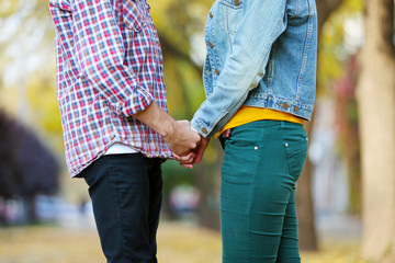 Loving couple holding hands outdoors