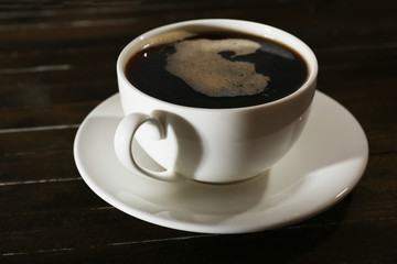 Cup of coffee on wooden table
