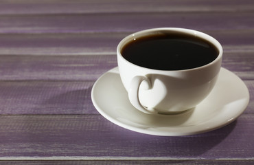 Cup of coffee on wooden table