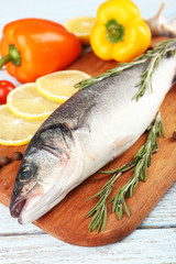 Fresh raw fish and food ingredients on table