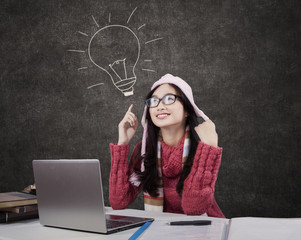 Female student in winter clothes in class