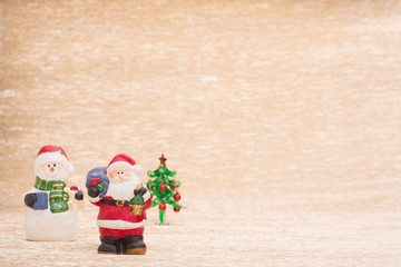 Santa Claus and snowman with fir tree on illuminated background