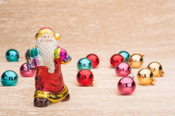 Santa Claus with Сhristmas balls on illuminated background