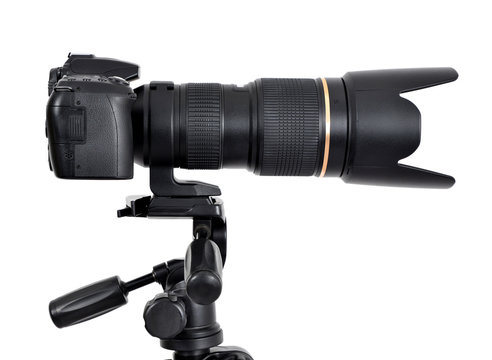 DSLR camera with zoom lense on a tripod isolated