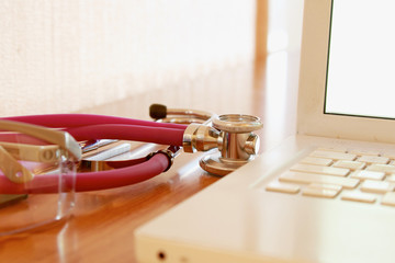 Laptop,glasses and stethoscope