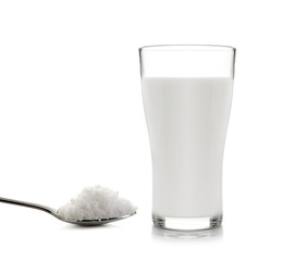 glass of milk  with sugar on a white background