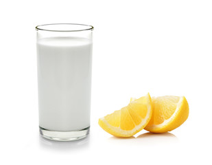 Glass of milk and Half lemon fruit on white background