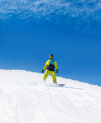 Fototapeta na wymiar Snowboarder sliding down hill, snow snowboarding