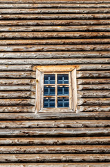 Window in the side wall of historic log cabin