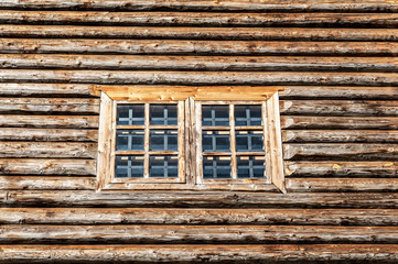 Window in the side wall of historic log cabin