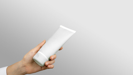 Girl's hand with white tube