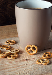A Cup of hot coffee and biscuits lying on the table