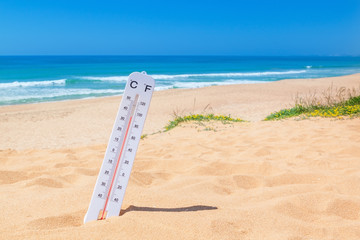 The heat on the beach. Thermometer for temperature weather.