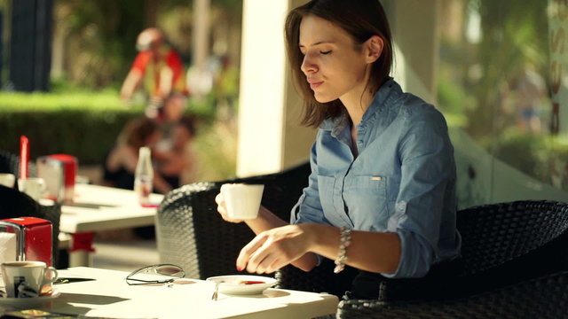 Beautiful businesswoman drinking and enjoying tasty coffee in ca