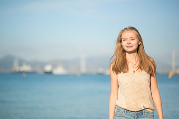 Fototapeta na wymiar Beautiful young girl on the beach in Cannes