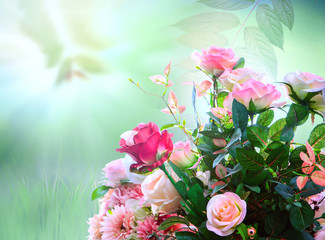 artificial roses flowers bouquet arrangement against green blur