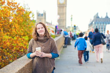 Tourist in London walking on with coffee