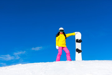 Fototapeta na wymiar snowboarder girl standing hold snowboard, snow mountain slope