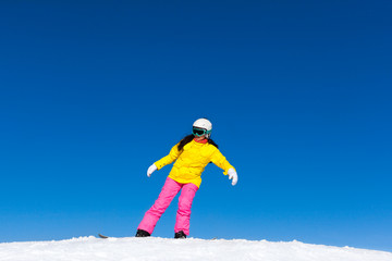 snowboarder girl making stunt trick on snowboard
