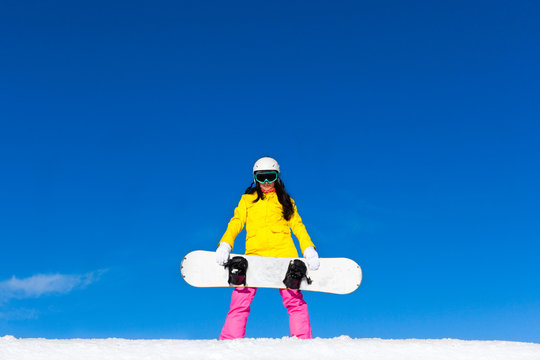 snowboarder girl standing hold snowboard, snow mountain slope