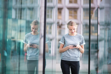 Young business woman using the mobile phone