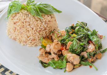 Fried chicken with sweet basil leave on brown rice