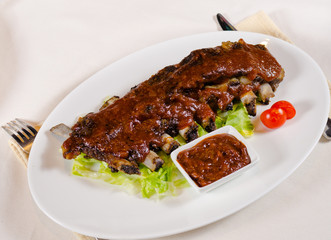 Rack of Saucy Barbecue Pork Ribs on White Plate