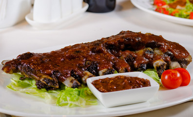 Rack of Saucy Barbecue Pork Ribs on White Plate