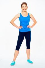 fitness woman in sport style standing against white background