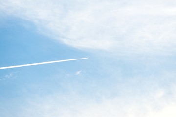 Airplane moving across blue sky