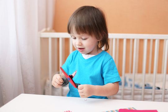 lovely toddler boy with scissors