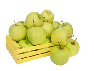 Golden Delicious apples tumble out of yellow box, isolated