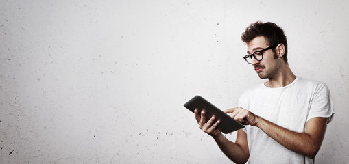 Hipster trying to use digital tablet