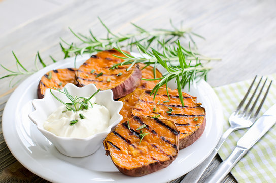 Healthy sweet potato baked and grilled with rosemary and sauce