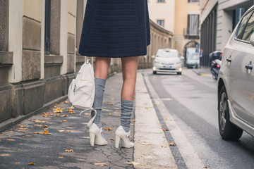 Detail of a beautiful girl posing in the city streets