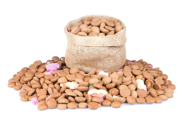 Jute bag filled with ginger nuts isolated over white