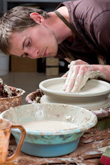 hands of a potter, creating an earthen jar